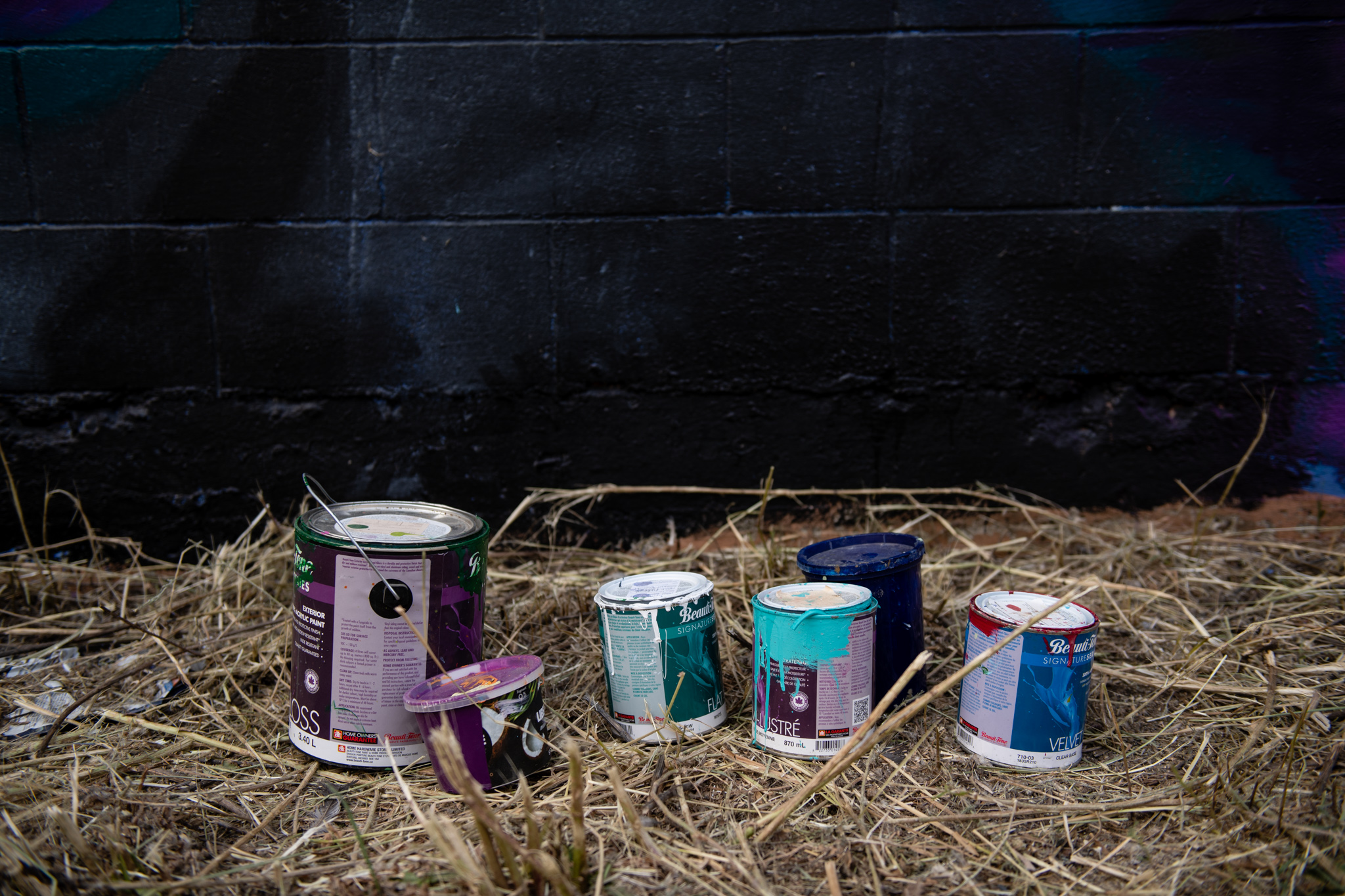 Paint cans against empty wall