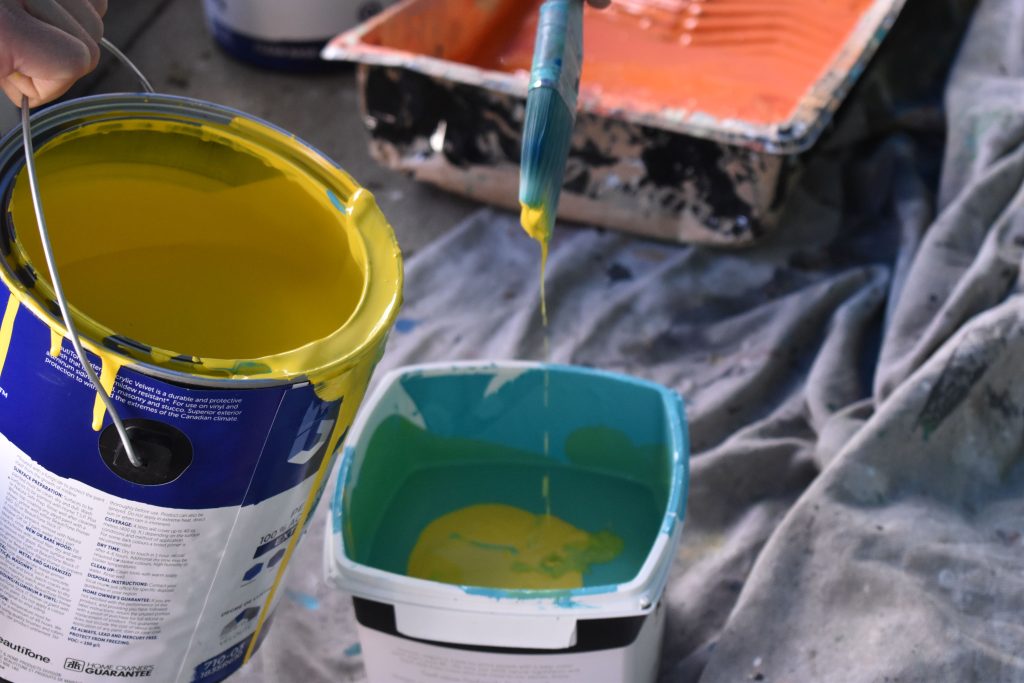 Mixing paint, yellow and blue